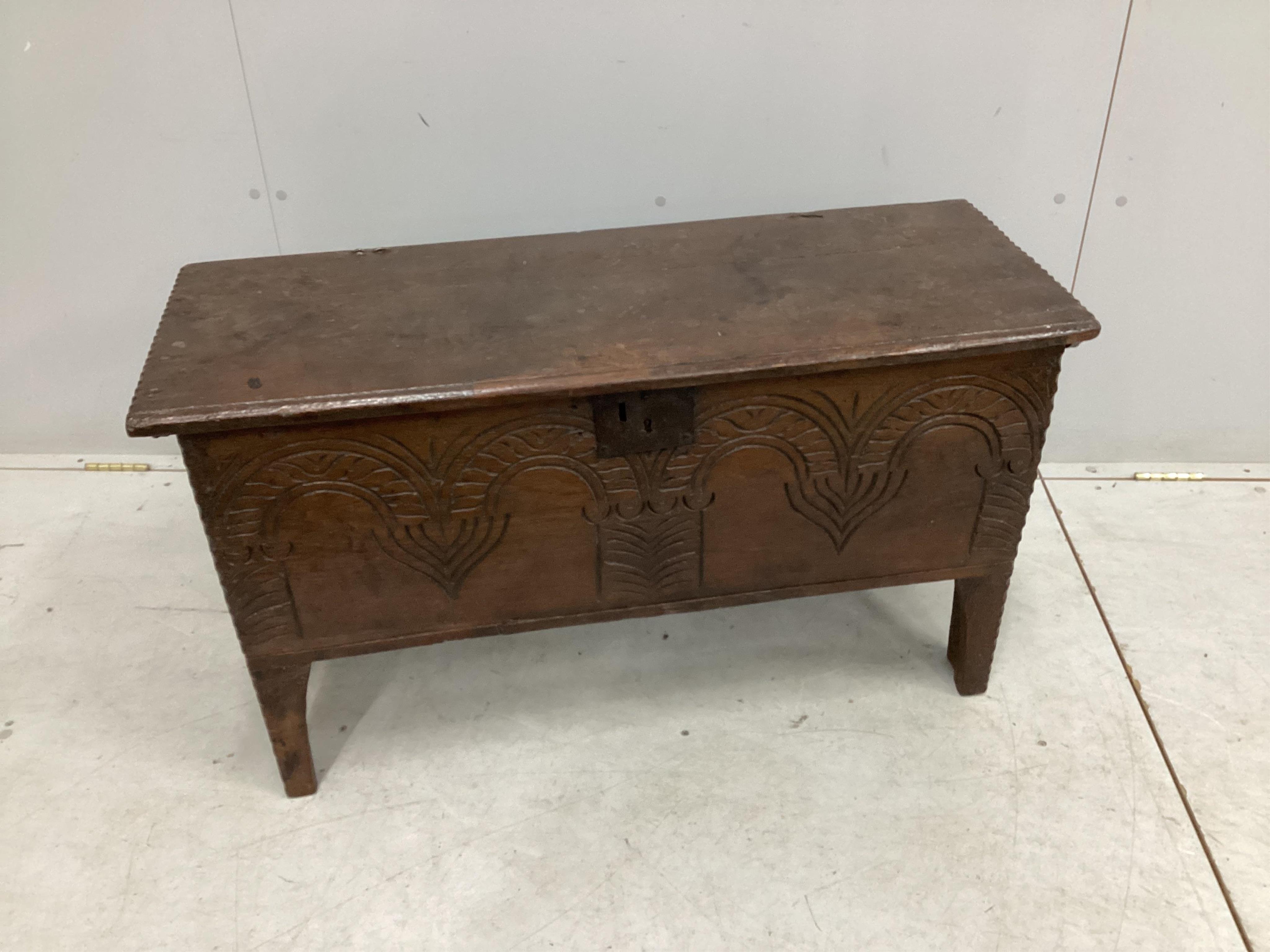 A small 17th century carved oak six plank coffer, width 96cm, depth 37cm, height 54cm. Condition - fair